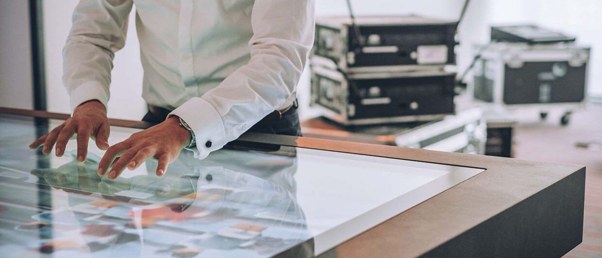 digital event area with man working on a touch screen table