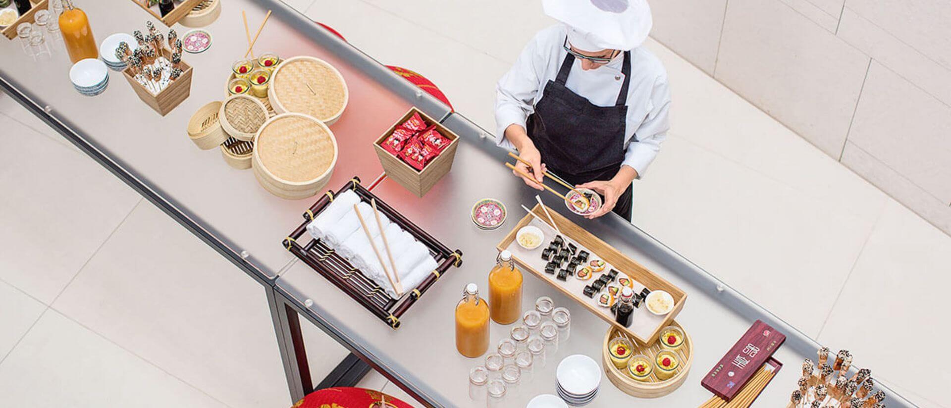 aerial view of cook setting food on a creative buffet