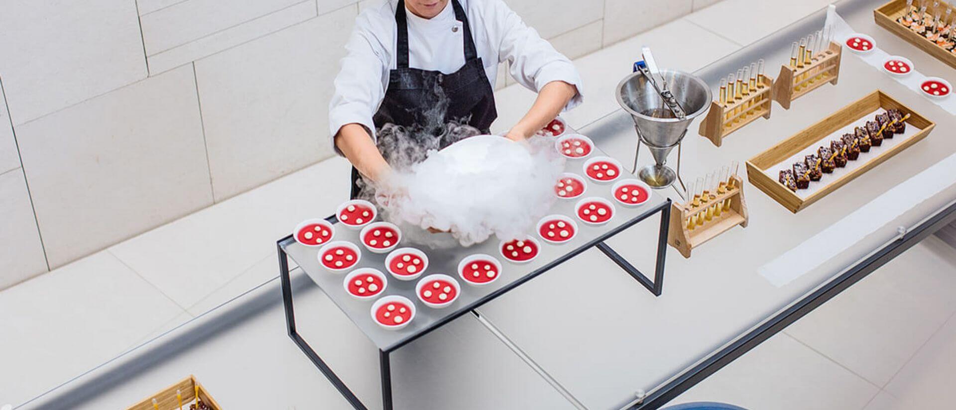 cook preparing food on a buffet for an event